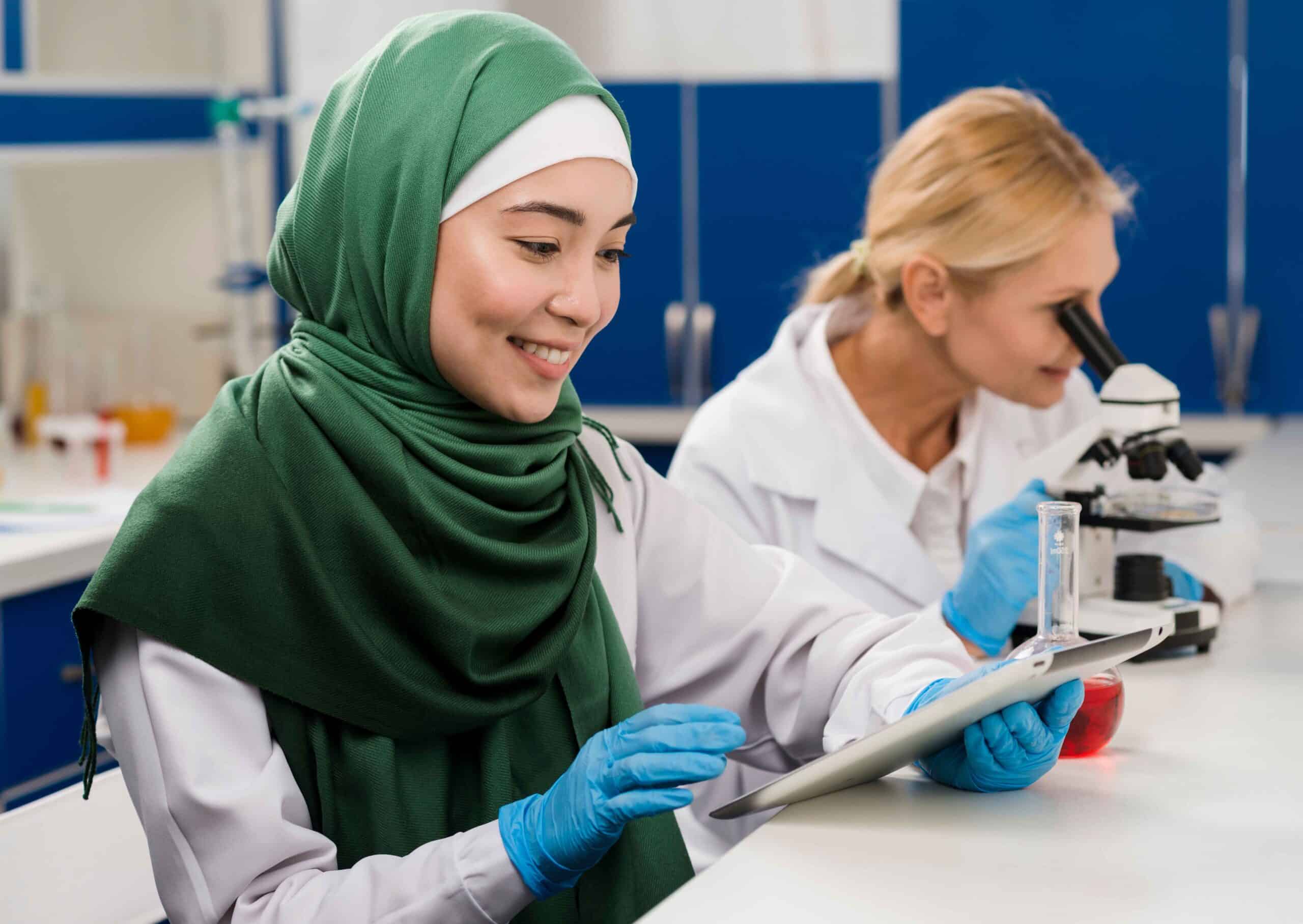 side-view-female-scientists-lab-working-together-scaled